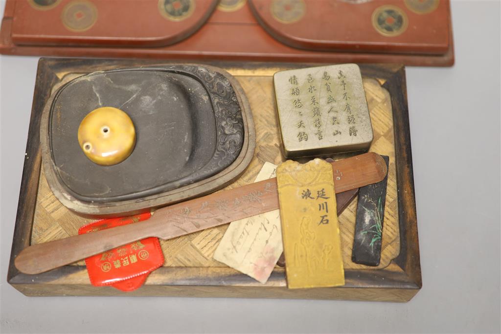 A group of Chinese and Japanese objects, 19th/20th century, including an inscribed ink box an inkstone, a lacquer bookslide, two Tibeta